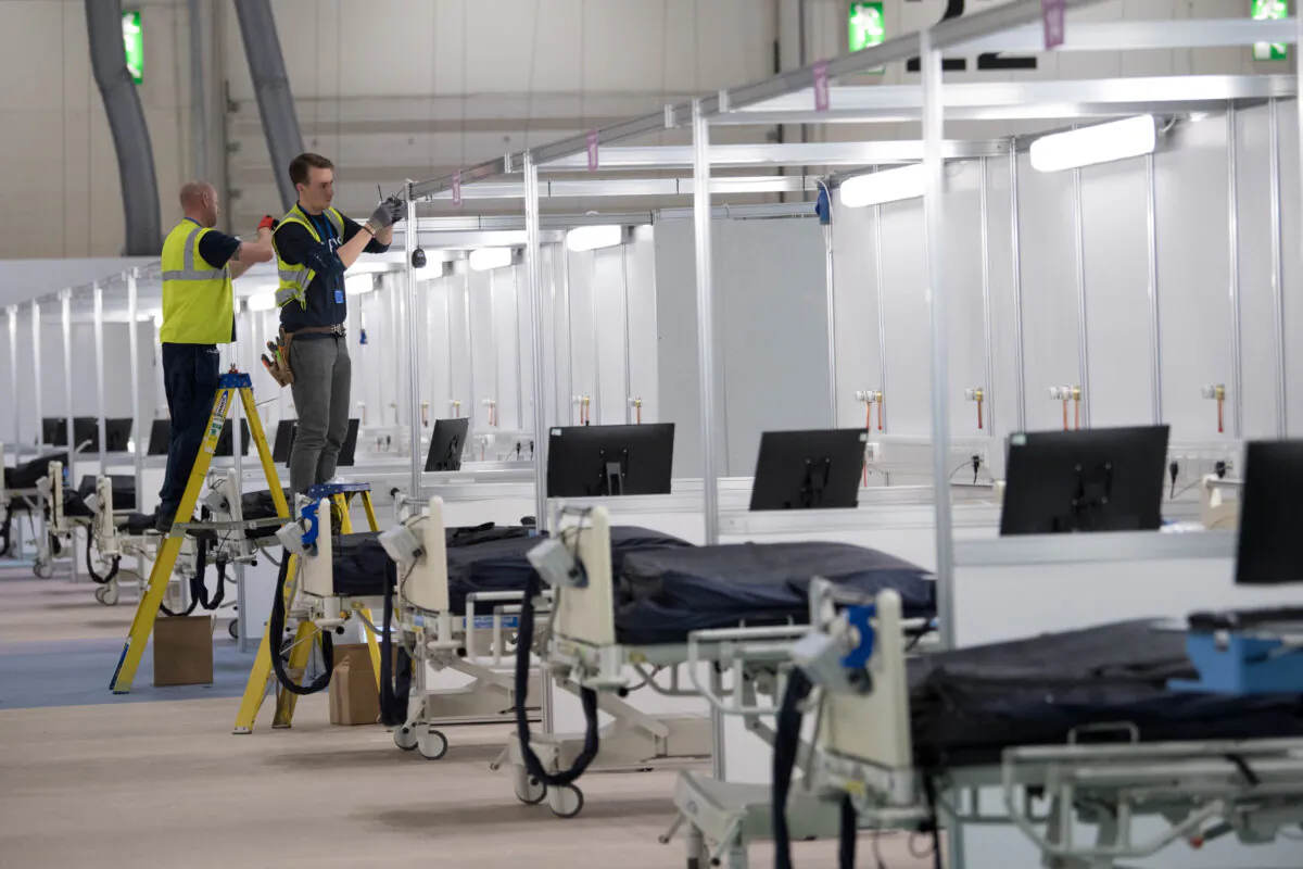 Work continues at ExCel London, during its conversion into the temporary NHS Nightingale Hospital, comprising of two wards, each of 2,000 people, to help tackle the CCP virus outbreak, in London on March 31, 2020. (Stefan Rousseau/Pool via Reuters)