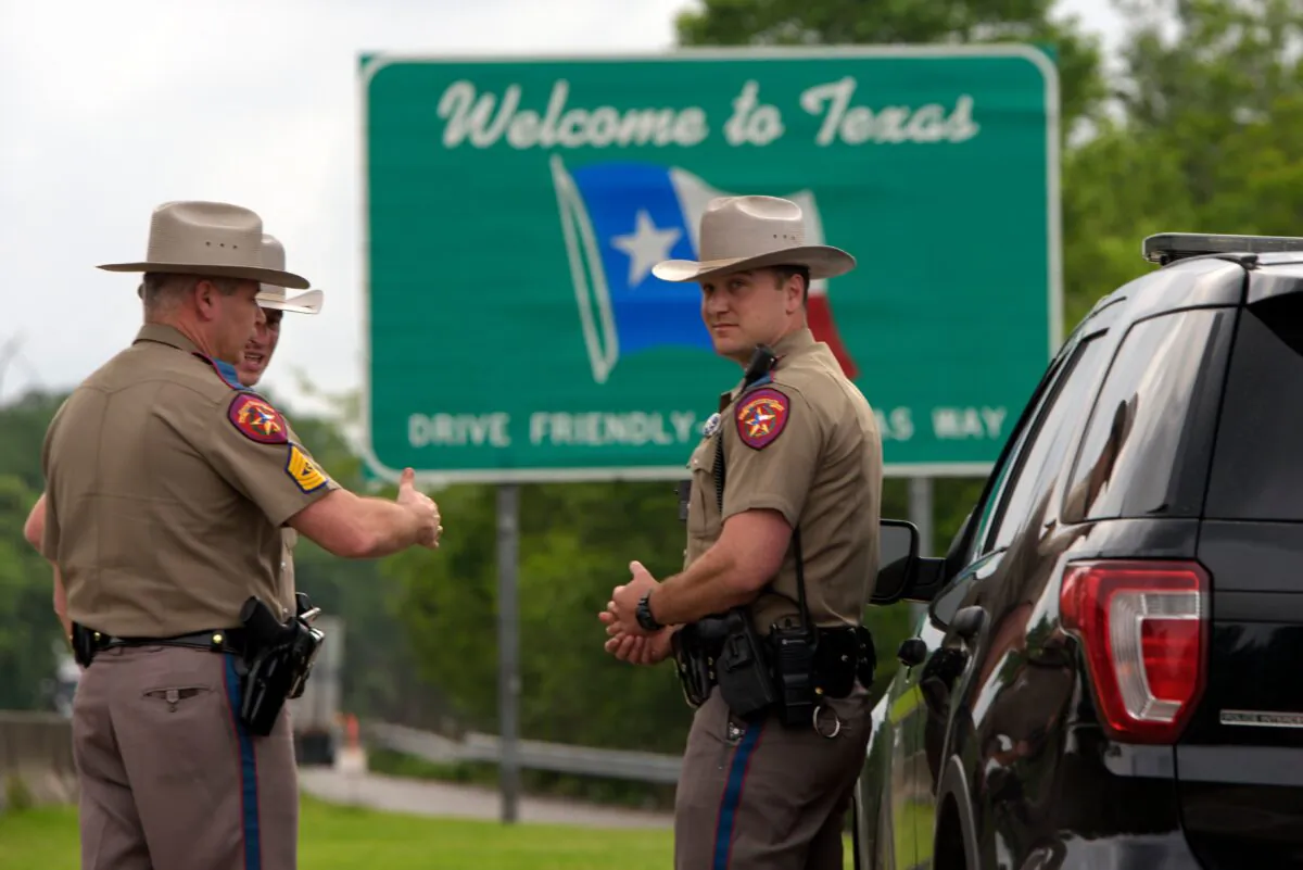 Texas State troopers patrol I-10 in Orange, Tex. across the border from Louisiana on March 30, 2020. (Mark Feli/AFP via Getty Images)