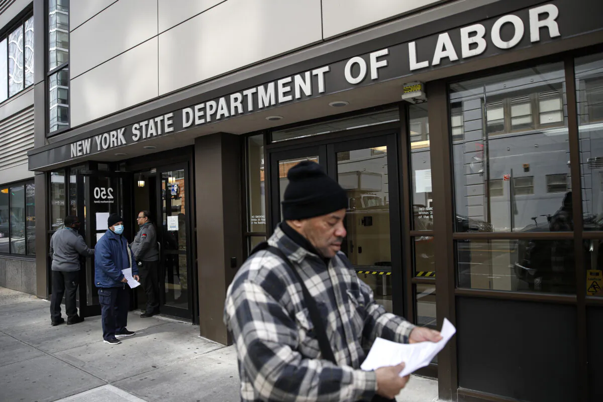 Visitors to the New York State Department of Labor are turned away at the door by personnel, due to closures over CCP virus concerns in New York City, N.Y., on March 18, 2020. (John Minchillo/AP Photo)