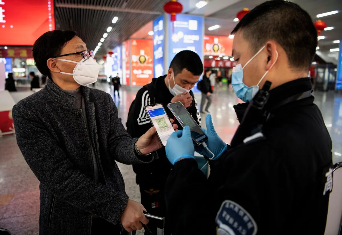 A passenger shows a green QR code on his phone to show his health status to security upon arrival at Wenzhou railway station in Wenzhou, Zhejiang on February 28, 2020. (NOEL CELIS/AFP via Getty Images)
