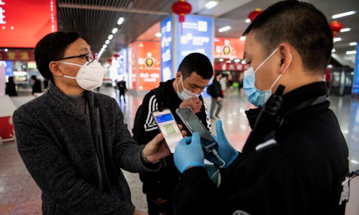 A passenger shows a green QR code on his phone to show his health status to security upon arrival at Wenzhou railway station in Wenzhou, Zhejiang on February 28, 2020. (NOEL CELIS/AFP via Getty Images)