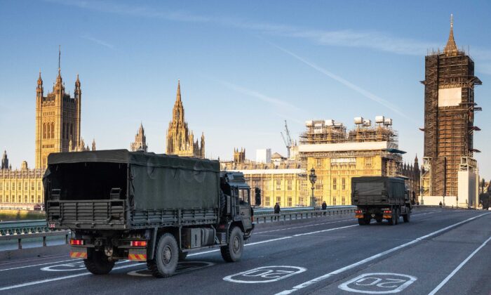Military vehicles cross Westminster Bridge after members of the 101 Logistic Brigade of the British Army delivered a consignment of medical masks to St Thomas' hospital in London, England, on March 24, 2020. (Leon Neal/Getty Images)