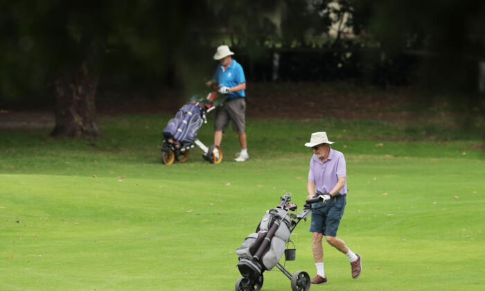 Golfers walk across the course at Woollahra Golf Club in Sydney, Australia, where golf is still allowed amid COVID-19 preventative measures, on April 2, 2020. (Matt King/Getty Images)