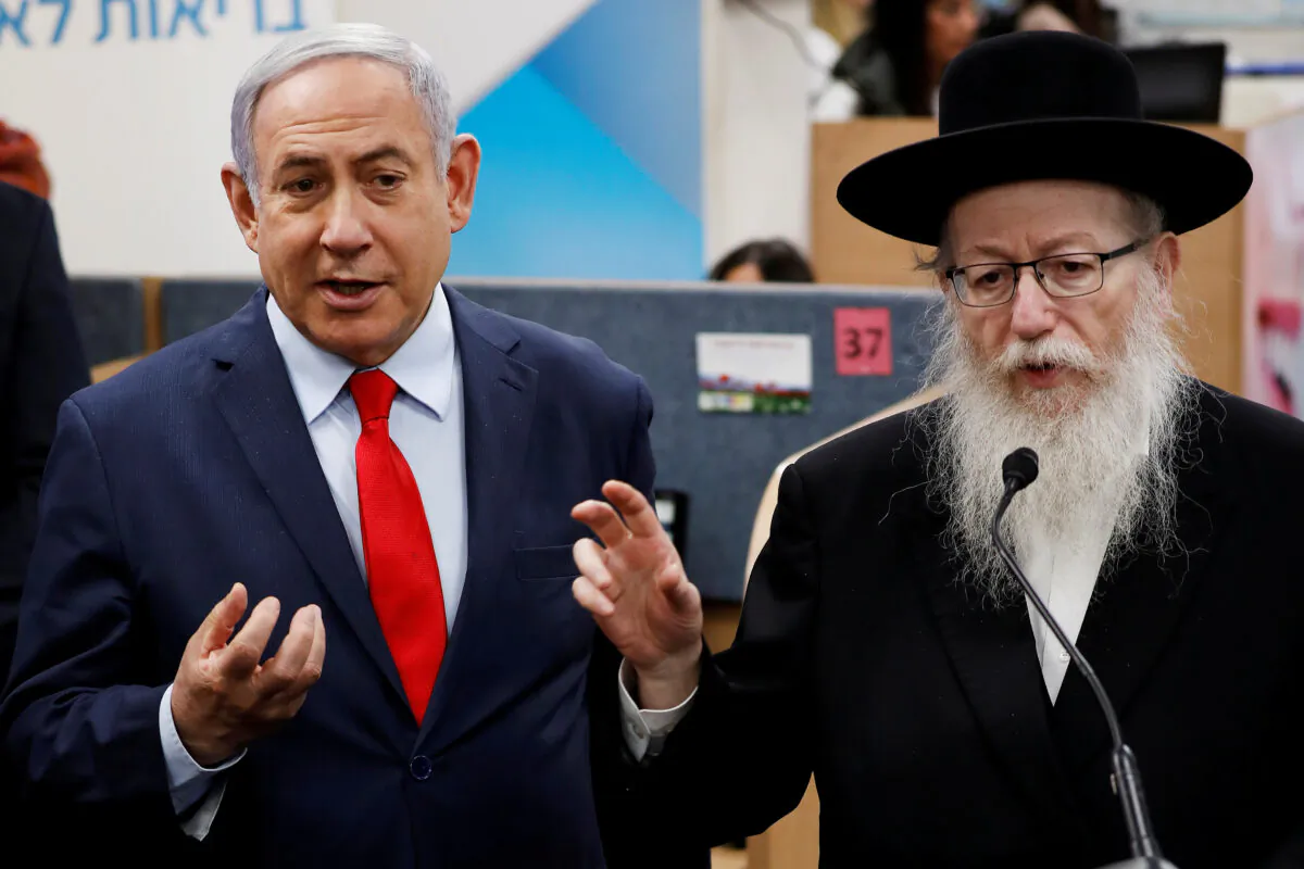 Israeli Prime Minister Benjamin Netanyahu and Health Minister Yaakov Litzman gesture as they deliver statements during a visit to the Health Ministry national hotline, in Kiryat Malachi, Israel, on March 1, 2020. (Reuters/Amir Cohen/File Photo)