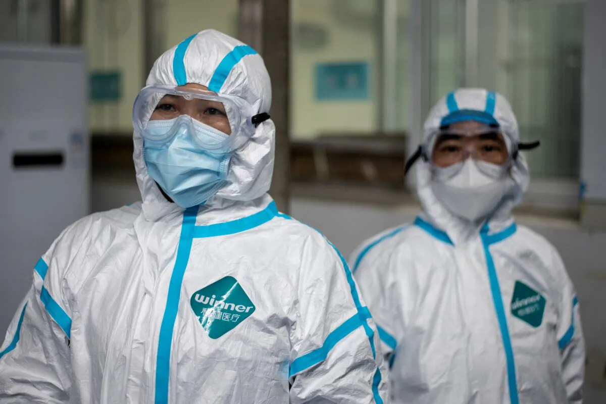 Medical workers wearing hazmat suits as a preventive measure against the COVID-19 coronavirus are seen at a fever clinic in Huanggang Zhongxin Hospital in Huanggang, in Chinas central Hubei province on March 26, 2020. (Noel Celis/AFP via Getty Images)