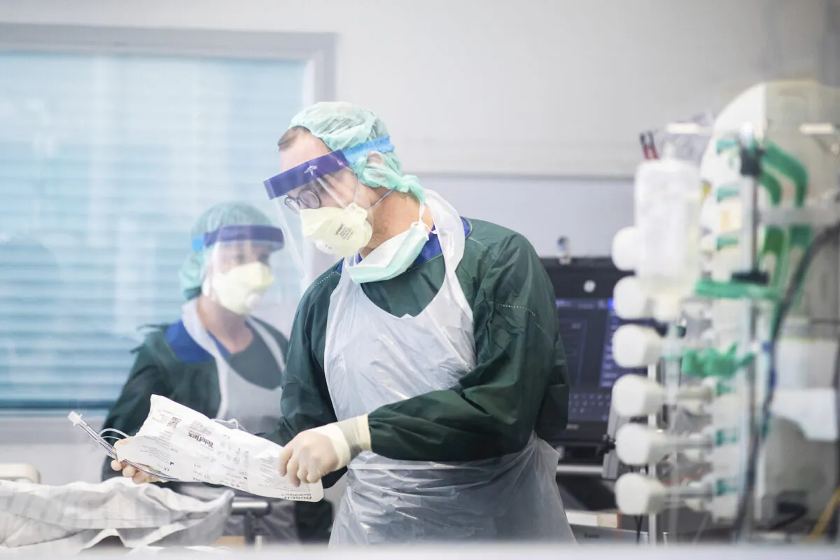 Medics attend to a COVID-19 patient at the University Hospital in Essen, Germany, on April 1, 2020. (Marcel Kusch/dpa via AP)