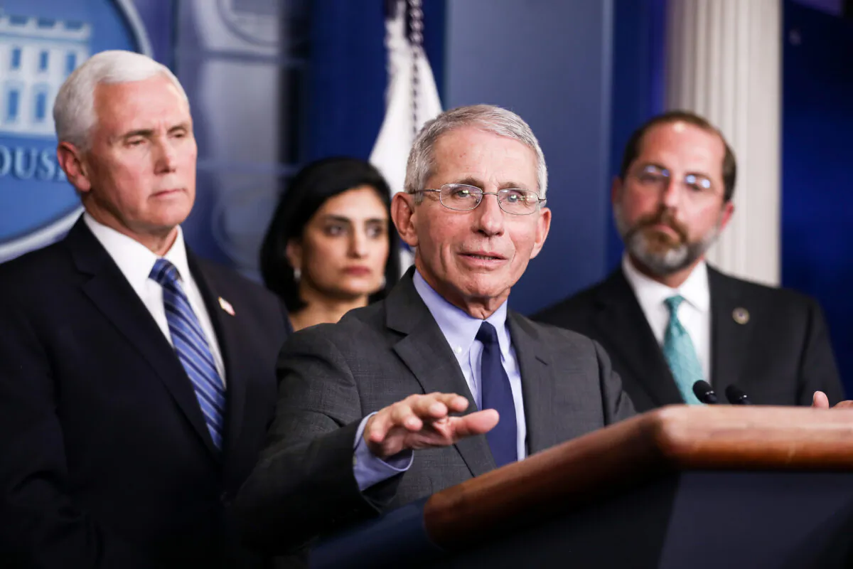 Dr. Anthony Fauci answers a question during a press conference as members of the administration look on, at the White House in Washington, on March 2, 2020. (Charlotte Cuthbertson/The Epoch Times)