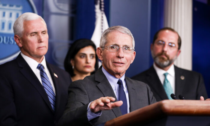 Dr. Anthony Fauci answers a question during a press conference as members of the administration look on, at the White House in Washington, on March 2, 2020. (Charlotte Cuthbertson/The Epoch Times)