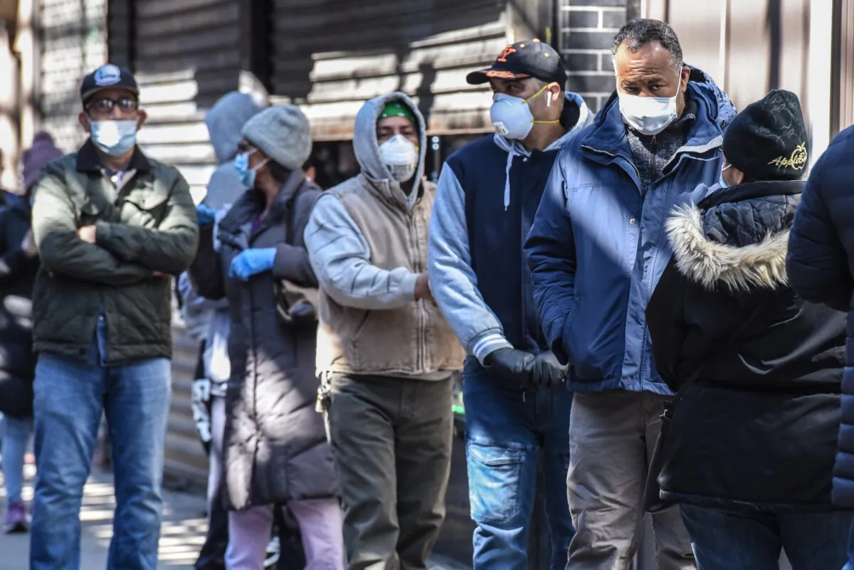 People stand in line in New York City on April 1, 2020. (Stephanie Keith/Getty Images)