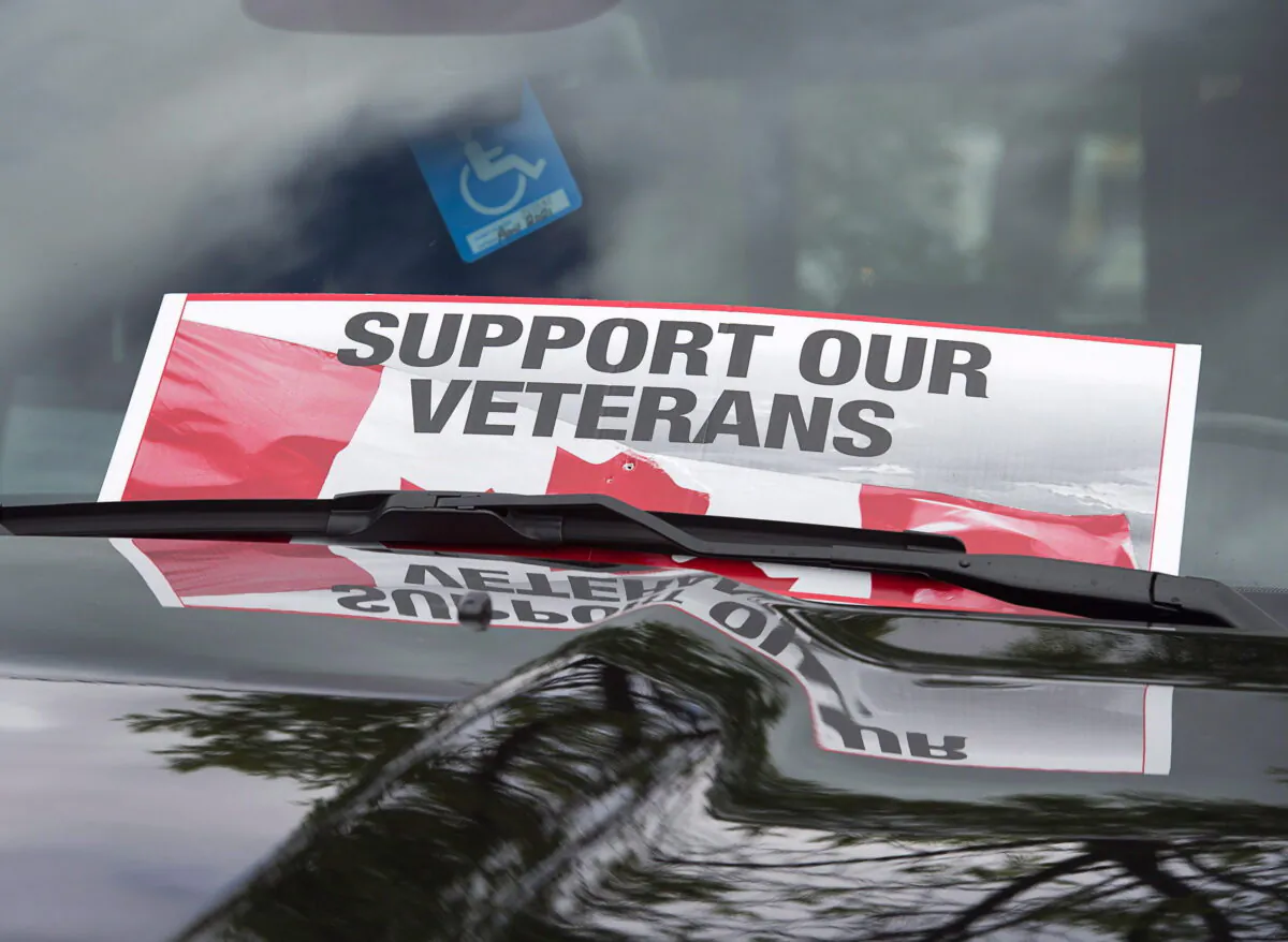 A sign is placed on a truck windshield, in a file photo, as members of the advocacy group Banished Veterans protest outside the Veterans Affairs office in Halifax. (Andrew Vaughan/The Canadian Press)
