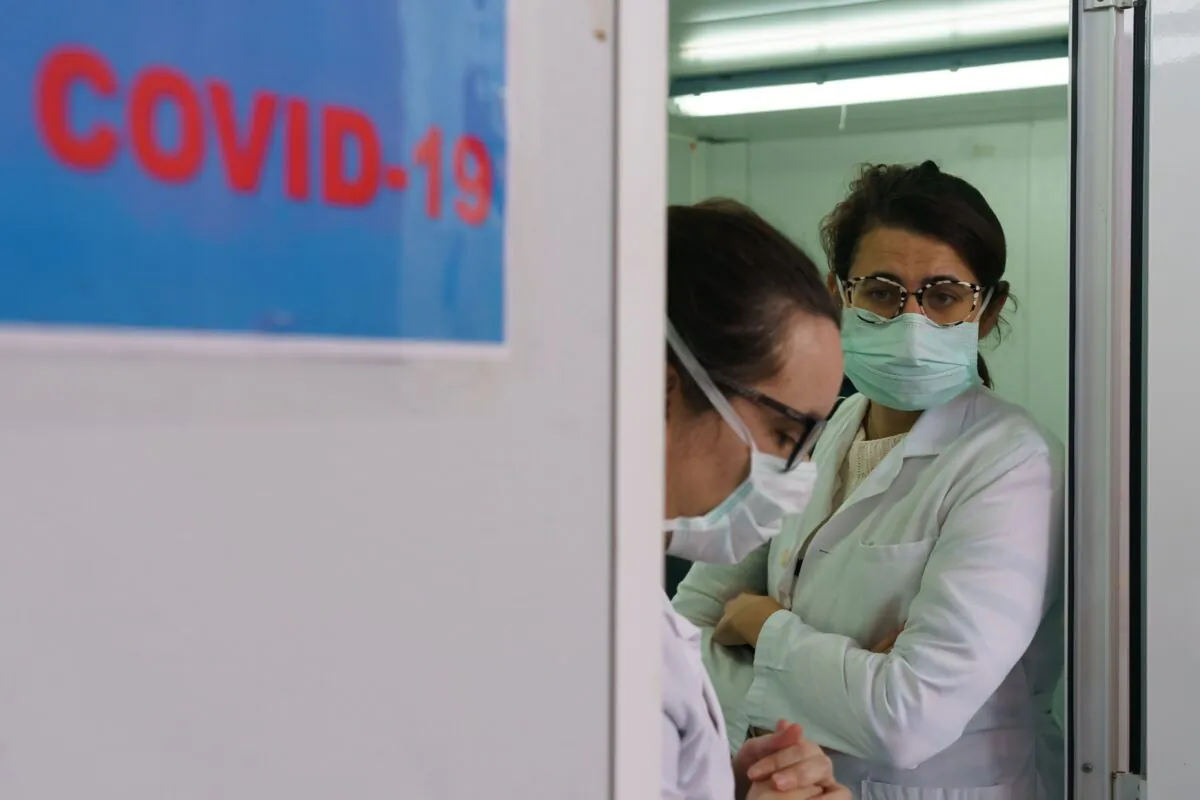 Health workers wait at the external screening area of the Burgos Hospital set up in order to separate patients with suspected CCP virus symptoms from the rest of the patients ahead of their admission in Burgos in northern Spain on April 2, 2020. (Cesar Manso/AFP via Getty Images)