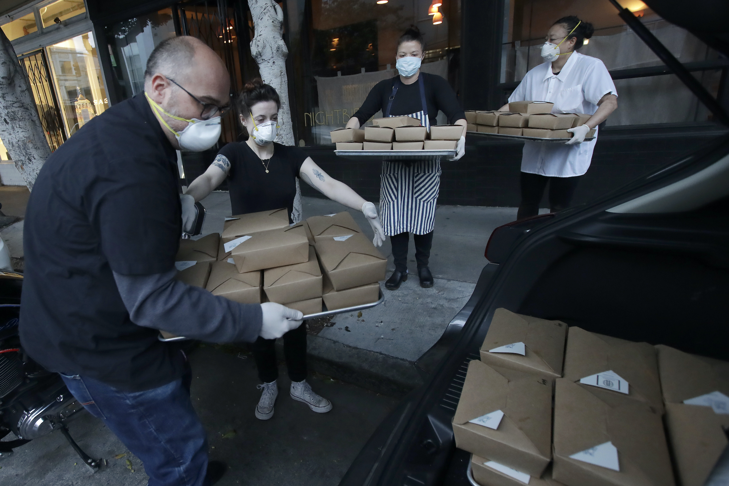 packing dinner boxes into car