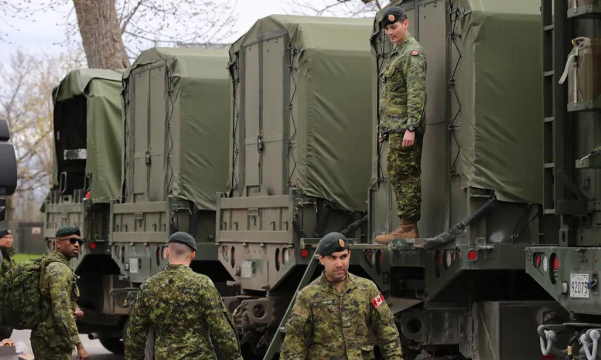 Reservists help pack military vehicles with boats and fuel at CFB Kingston Kingston, Ont., on May 9, 2017.  (Lars Hagberg/The Canadian Press)