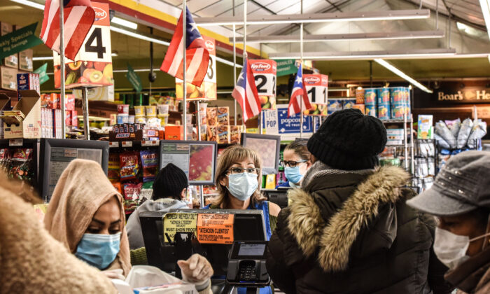 Cashiers wearing protective masks work in a grocery store in the Bushwick neighborhood of Brooklyn in New York City on April 2, 2020. (Stephanie Keith/Getty Images)