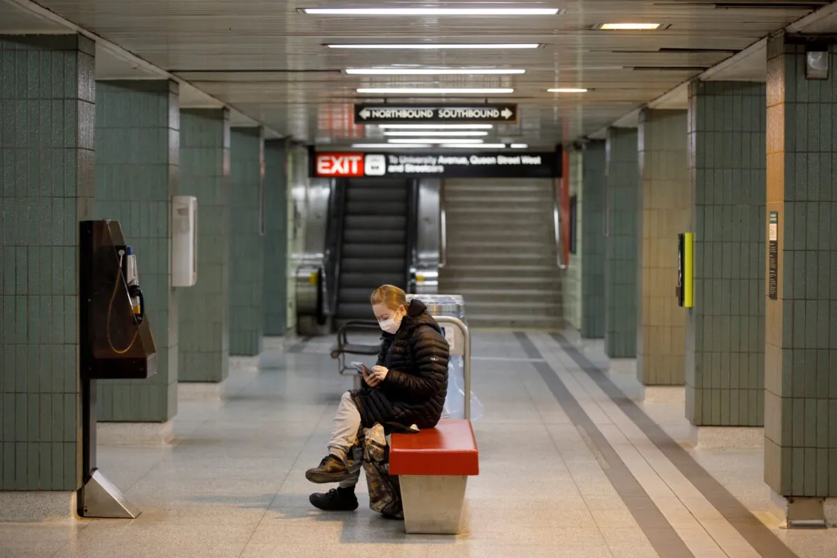 A woman wears a mask in the subway during morning commuting hours in Toronto on April 1, 2020. (Cole Burston/Getty Images)