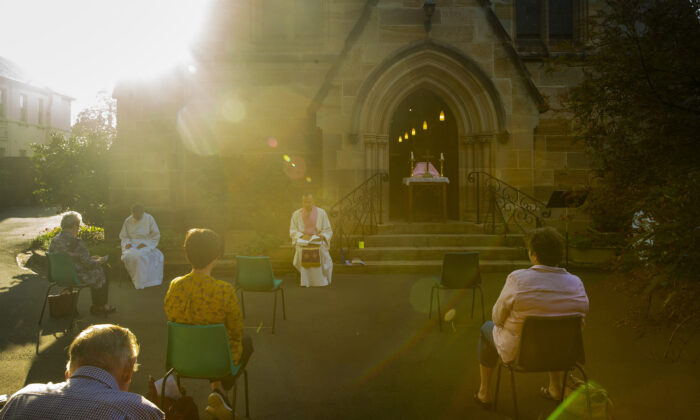 Father James Collins holds a service in the yard of St Paul's Anglican Church in Burwood with seating observant of social distancing on March 22, 2020 in Sydney, Australia.  (Jenny Evans/Getty Images)