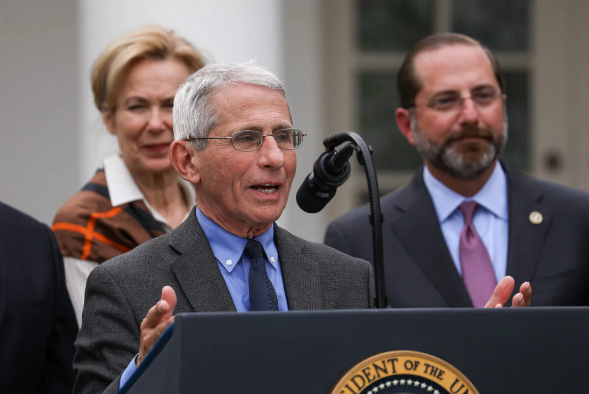 Director of the National Institute of Allergy and Infectious Diseases Anthony Fauci, flanked by officials and business leaders, speaks to media after President Donald Trump announced a national emergency with regard to the coronavirus in the White House Rose Garden in Washington on March 13, 2020. (Charlotte Cuthbertson/The Epoch Times)