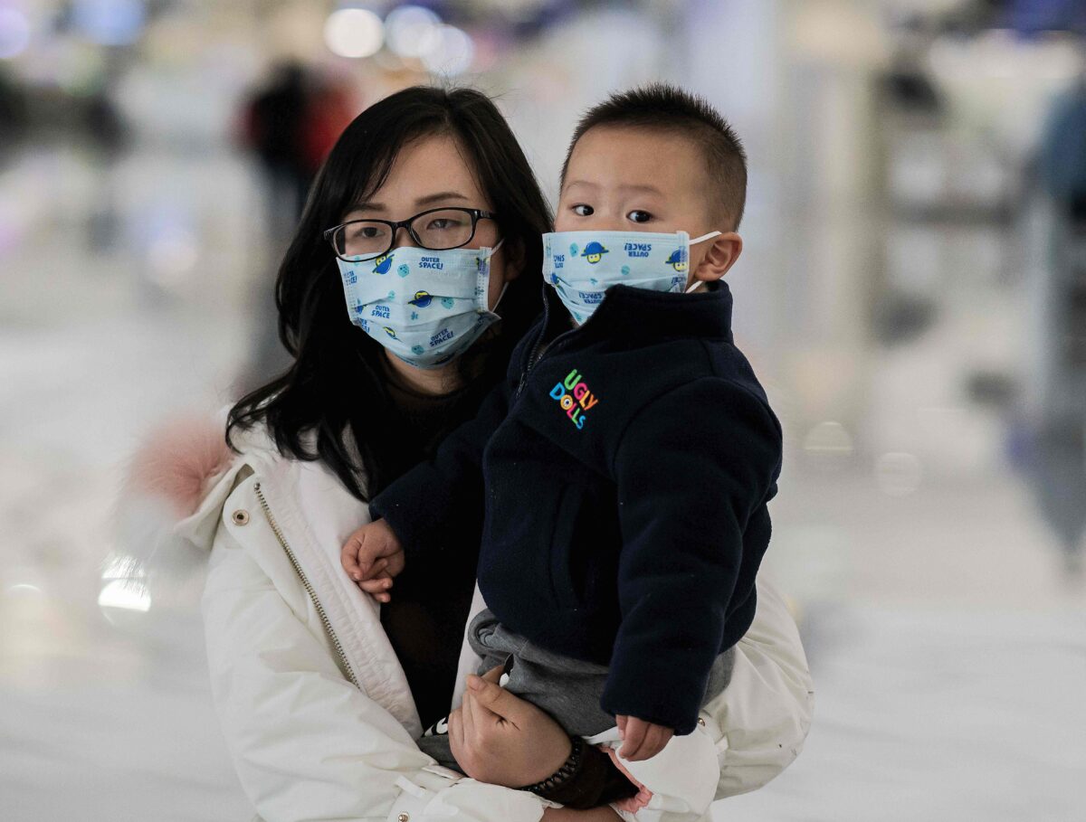 A woman and a child wearing protective masks