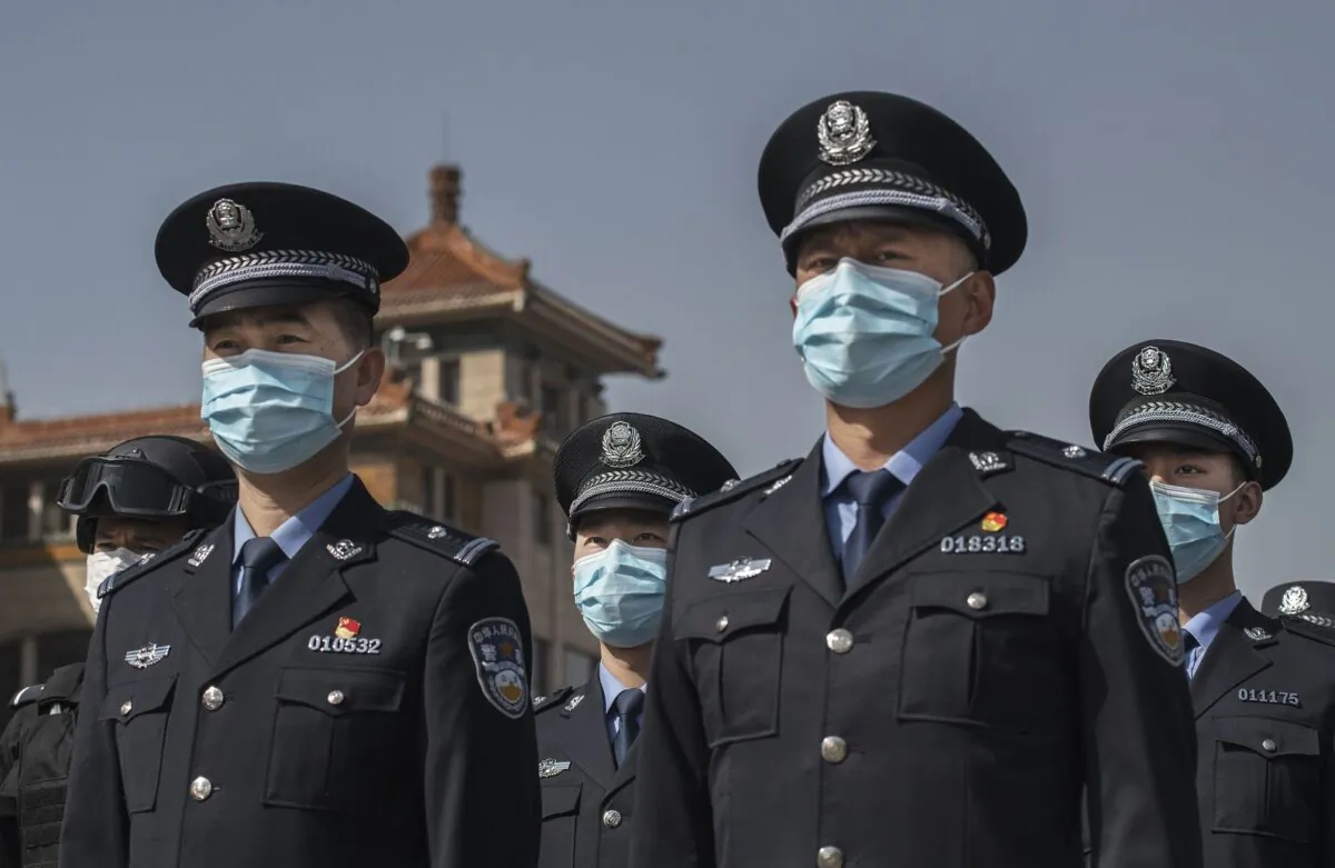 Chinese police officers wear protective masks at Beijing Railway Station on April 4, 2020. (Kevin Frayer/Getty Images)