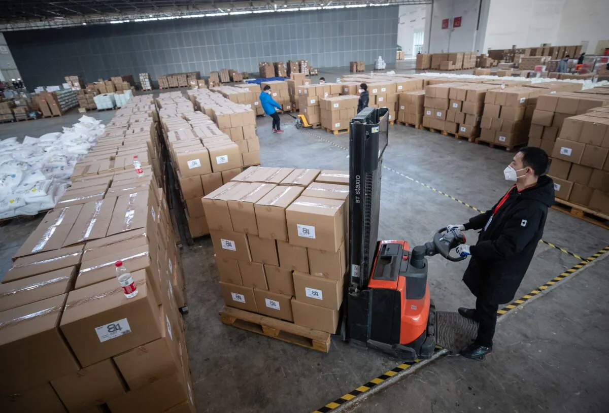 Staff members and volunteers are transferring medical supplies at a warehouse of an exhibition centre in Wuhan, China, on Feb. 4, 2020. (STR/AFP via Getty Images)