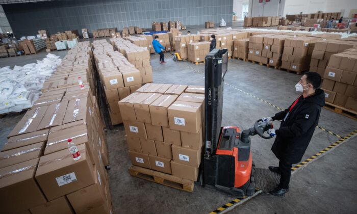 Staff members and volunteers are transferring medical supplies at a warehouse of an exhibition centre in Wuhan, China on Feb. 4, 2020. (STR/AFP via Getty Images)