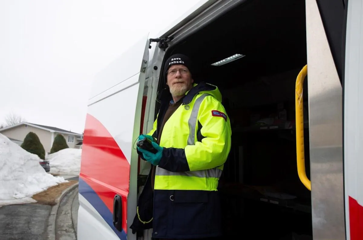 Craig Dyer, a postal worker, is back on the job delivering mail in Mount Pearl, Nfld., on April 3, 2020 following a two week isolation period when a co-worker tested positive for COVID-19. (Paul Daly/The Canadian Press)