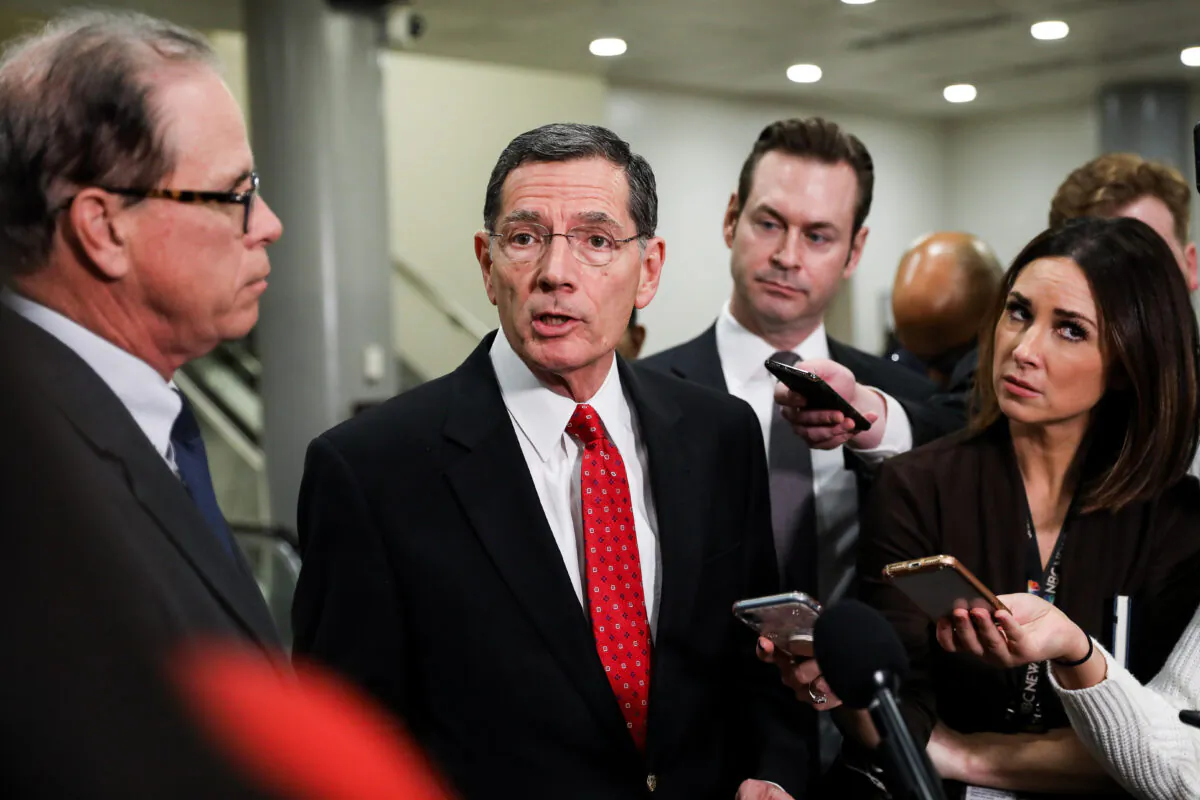 Sen. John Barrasso (R-Wyo.) speaks to media while Sen. Mike Braun (R-Ind.) (L) looks on at the Capitol in Washington on Jan. 27, 2020. (Charlotte Cuthbertson/The Epoch Times)