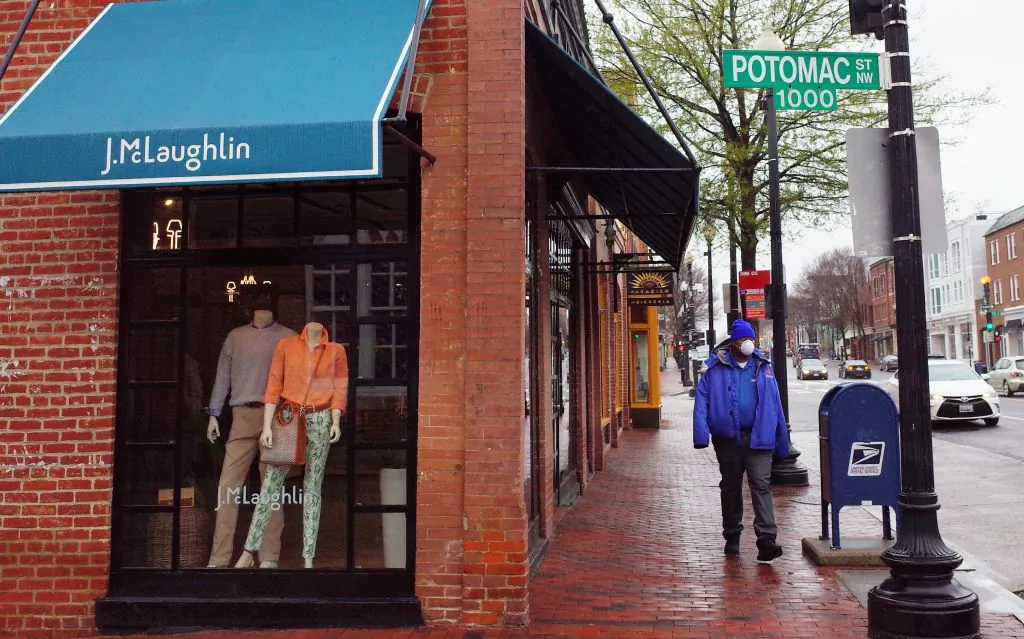 A man wears a mask while walking in the normally busy shopping district of Georgetown in Washington, D.C., on March 23, 2020. (Mandel Ngan/AFP via Getty Images)
