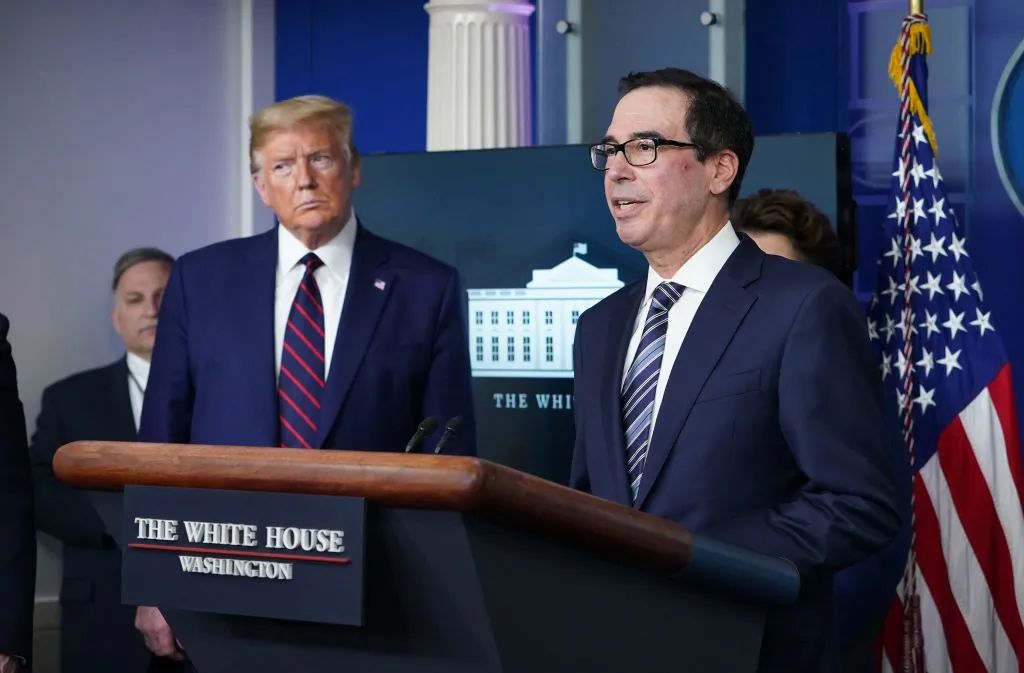 Secretary of the Treasury Steve Mnuchin speaks while President Donald Trump listens during the daily briefing on COVID-19 in the Brady Briefing Room at the White House in Washington on April 2, 2020. (Mandel Ngan/AFP via Getty Images)