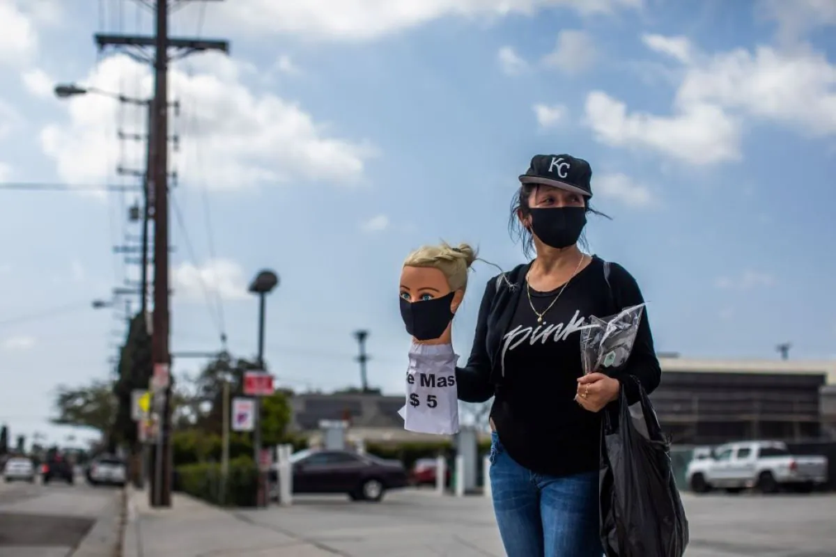 Dressmaker Flor Hernandez sells face masks on street after losing her job during the novel coronavirus (COVID-19) outbreak in Los Angeles, California on April 2, 2020. (APU GOMES/AFP via Getty Images)
