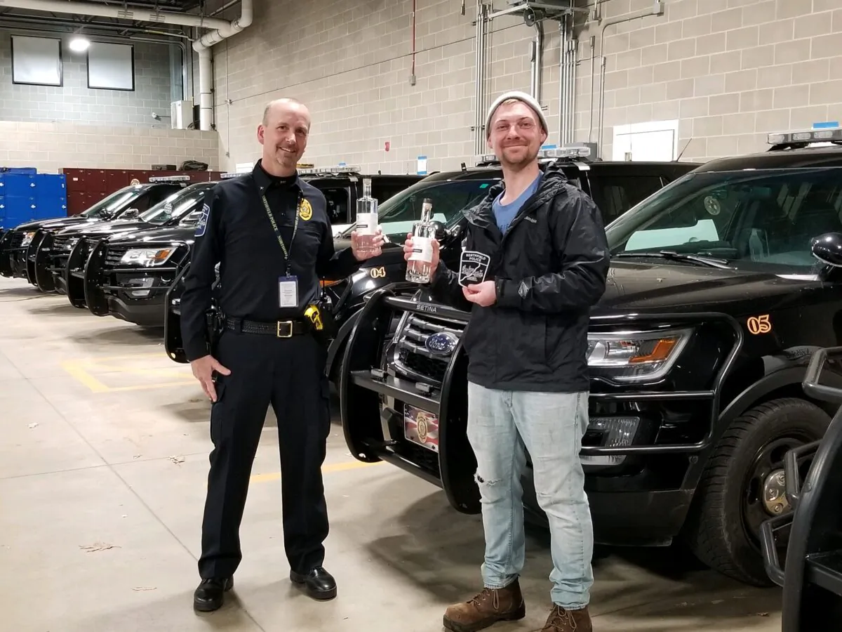 Mark Schiller (R) of Loon Liquor Co. provides sanitizer for local law enforcement. (Courtesy of Loon Liquor Company)