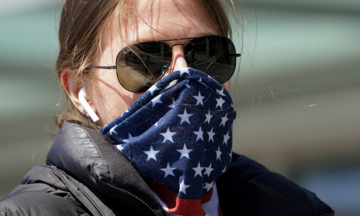 A woman wears a Stars and Stripes bandana for a face mask, amid COVID-19 fears, in Washington on April 2, 2020. (Kevin Lamarque/Reuters)