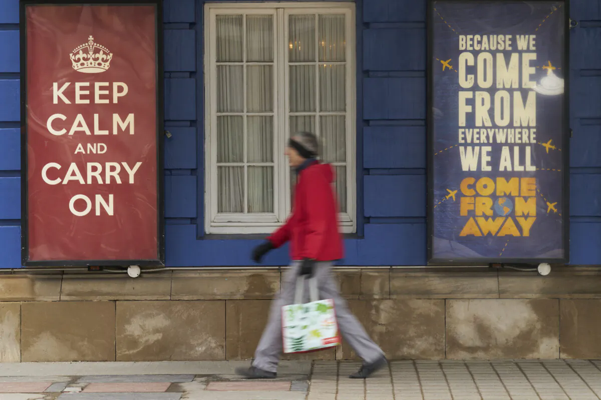 A woman walks past the Royal Alexandra Theatre in Toronto, Ontario, Canada, on March 24, 2020. (Geoff Robins / AFP via Getty Images)