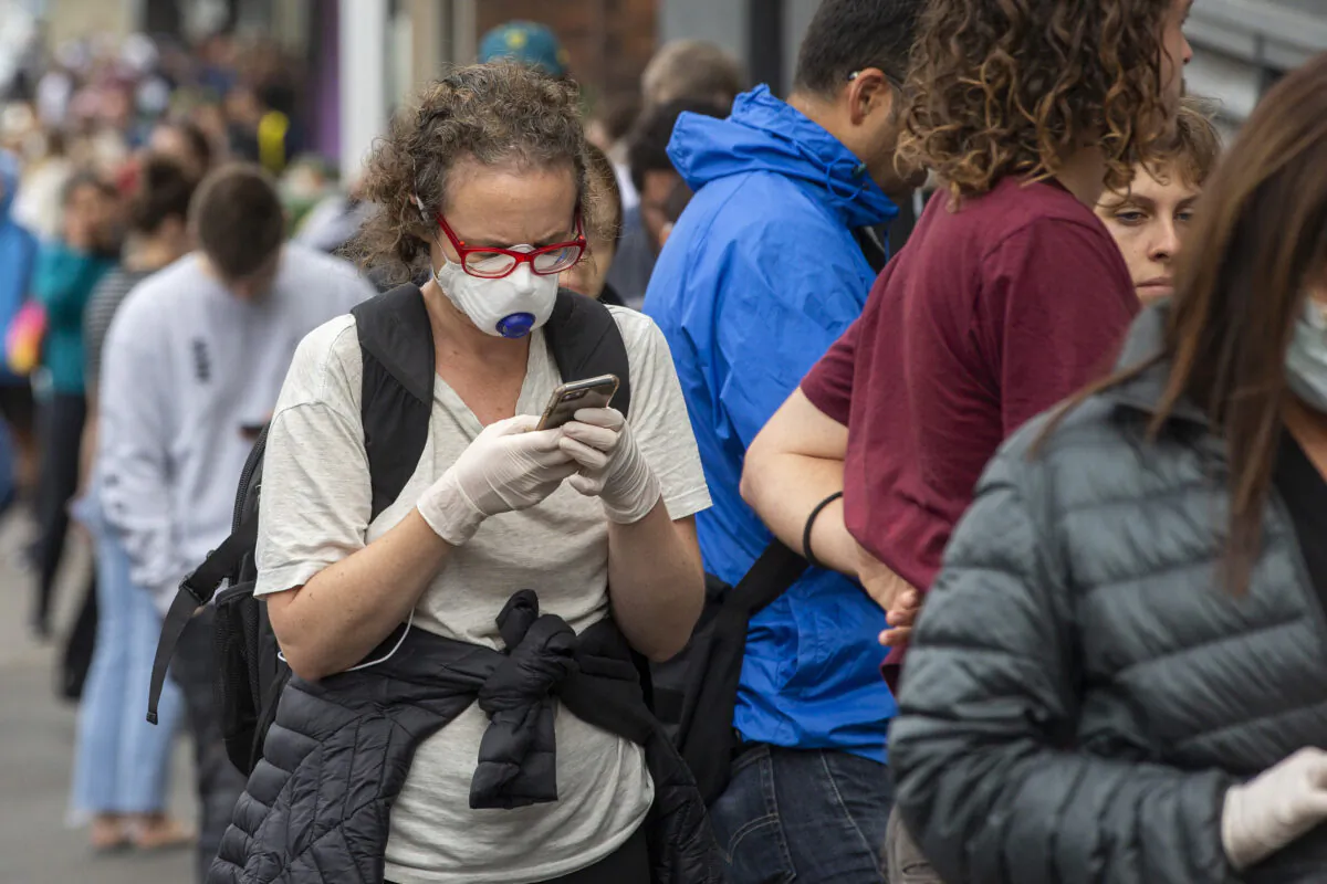 A woman in a mask is seen lining up at Centrelink in Bondi Junction on March 23, 2020 in Sydney, Australia. (Jenny Evans/Getty Images)