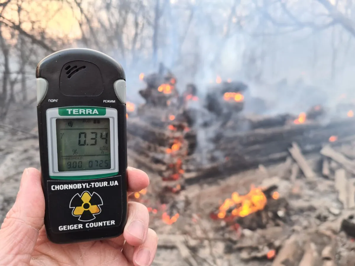 A person holds a Geiger counter at the scene of a forest fire at the Chernobyl exclusion zone, not far from the nuclear power plant, on April 5, 2020. (Yaroslav Emalianenko/AFP/Getty Images)