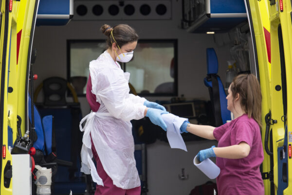 A hospital worker cleans an ambulance outside St Thomas' hospital