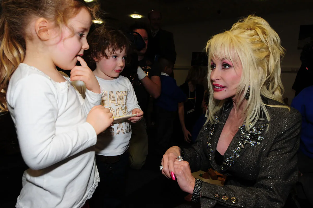 Country music superstar singer-songwriter Dolly Parton meets young children at the Magna Science and Adventure Park in Rotherham, England, on Dec. 5, 2007. Parton honored the former steelworks town to be the first European location to participate in her Imagination Library literacy project. (Pool/Getty Images)