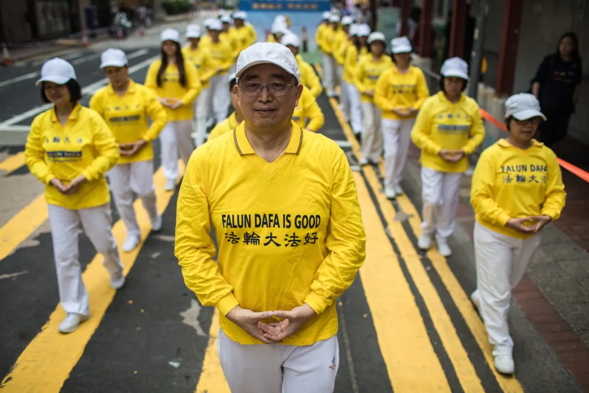 Supporters of the Falun Gong spiritual practice take part in a march in Hong Kong on April 27, 2019. (DALE DE LA REY/AFP via Getty Images)