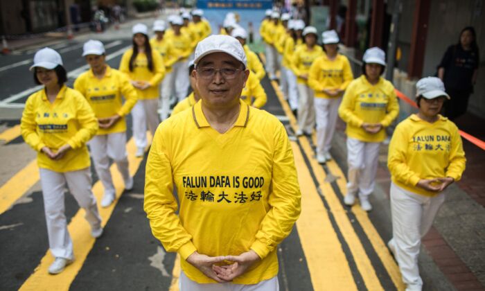 Supporters of the Falun Gong spiritual practice take part in a march in Hong Kong on April 27, 2019. (DALE DE LA REY/AFP via Getty Images)