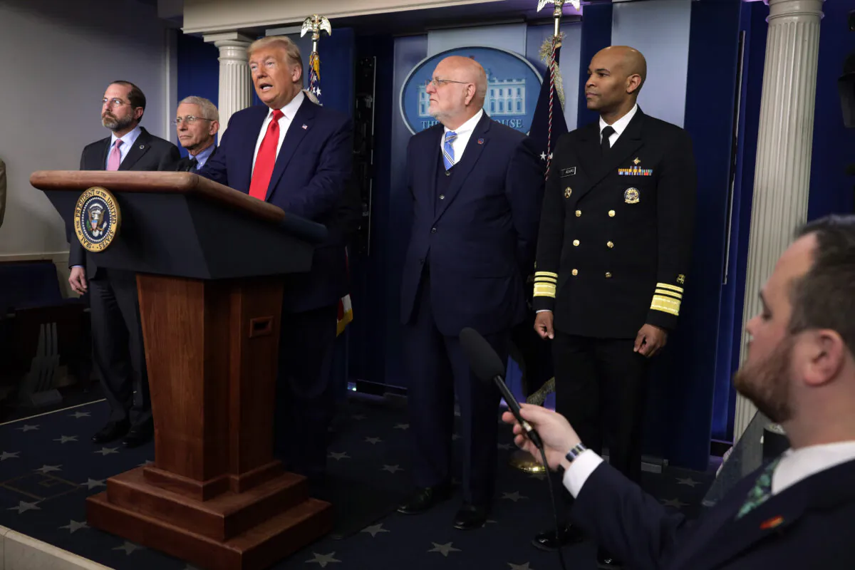 President Donald Trump speaks as top officials, including Dr. Robert Redfield, the CDC director (second from right) and Surgeon General Dr. Jerome Adams (R) listen in Washington on Feb. 29, 2020. (Alex Wong/Getty Images)