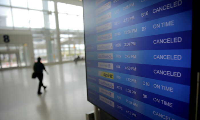 Canceled flights are seen on an airport screen in New Orleans, Louisiana on April 4, 2020. (Carlos Barria/File Photo/Reuters)