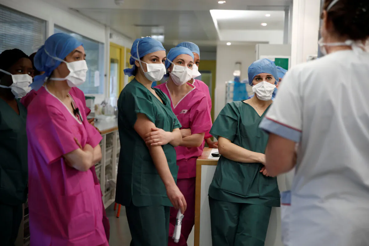 Medical staff attend a briefing at the intensive care unit for CCP virus patients at a hospital in Paris on April 6, 2020. (Benoit Tessier/Reuters)