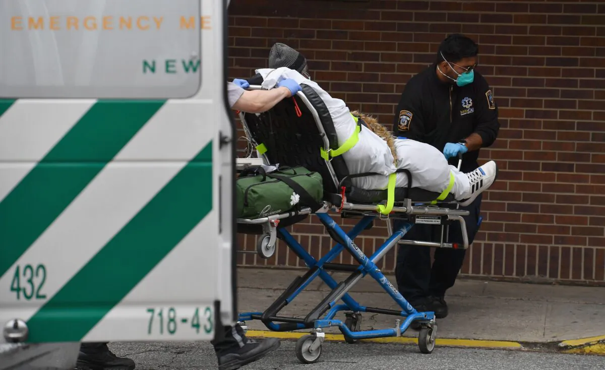 Paramedics push a gurney with a patient to the Brooklyn Hospital Center Emergency Room in New York City on March 31, 2020. (Angela Weiss/AFP via Getty Images)