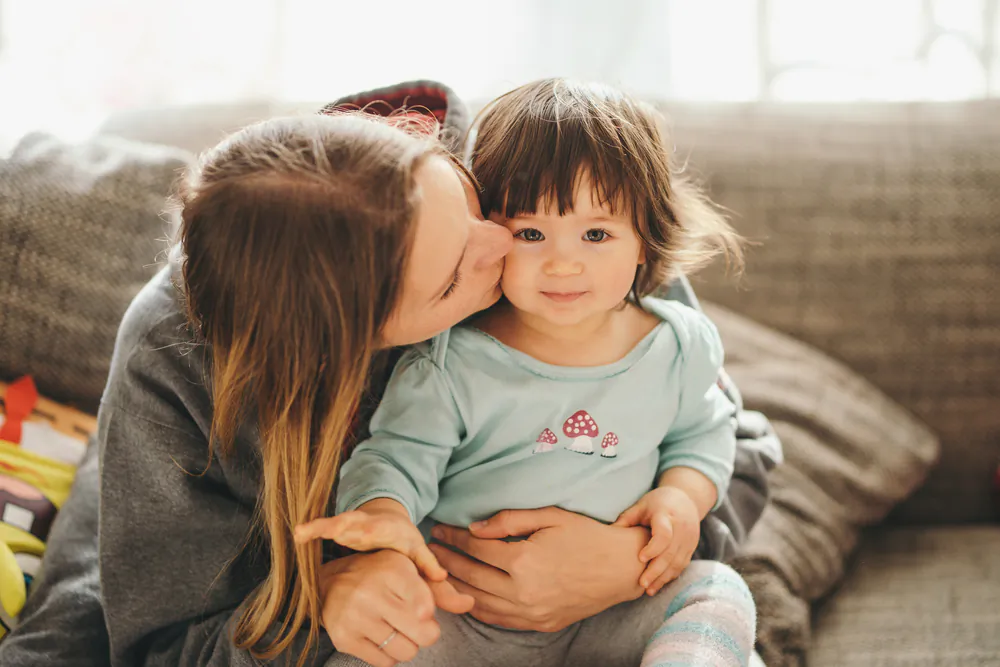 Some ideas for building warmth might include beginning the day with cuddles, some massage, a good story, or even some rough-and-tumble games on the bed if you’re up for it. (veryulissa/Shutterstock)