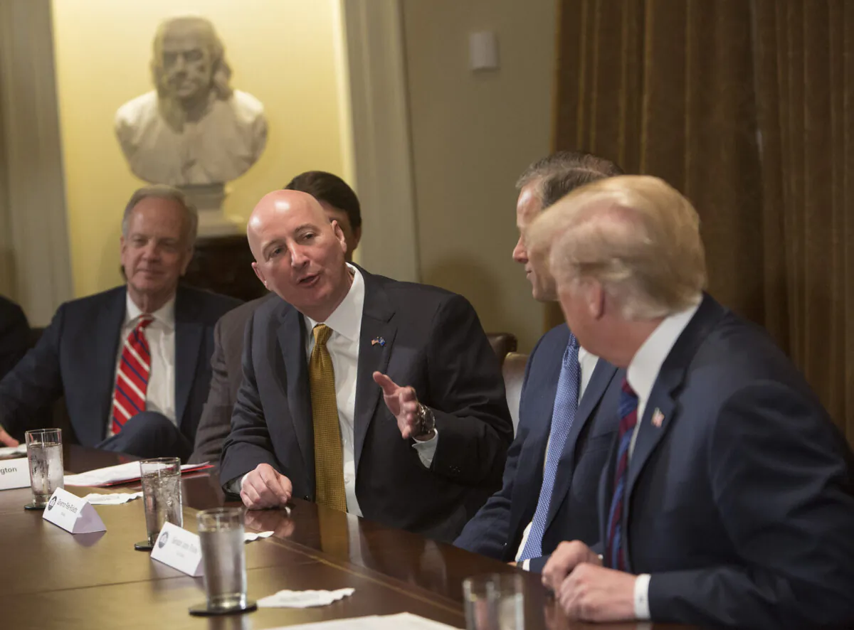 Nebraska Gov. Pete Ricketts speaks to then-President Donald Trump during a meeting on trade with governors and members of Congress at the White House in Washington on April 12, 2018. (Chris Kleponis/Pool/Getty Images)