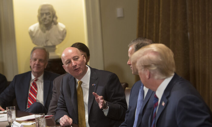 Nebraska Gov. Pete Ricketts speaks to then-President Donald Trump during a meeting on trade with governors and members of Congress at the White House in Washington on April 12, 2018. (Chris Kleponis - Pool/Getty Images)