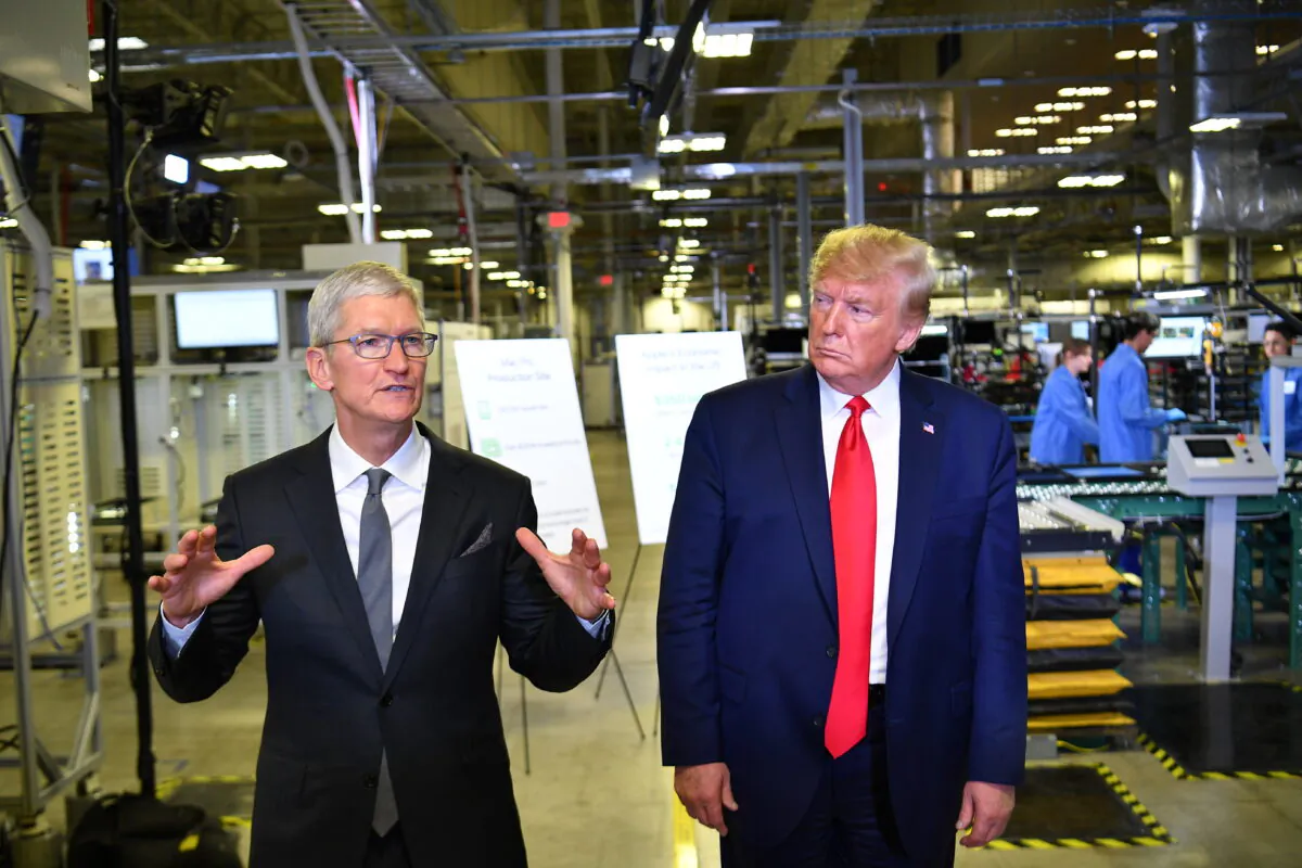 President Donald Trump and Apple CEO Tim Cook speak to the press during a tour of the Flextronics computer manufacturing facility where Apple's Mac Pros are assembled in Austin, Texas, on Nov. 20, 2019. (Mandel Ngan/AFP via Getty Images)