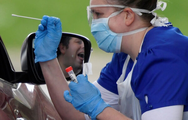 Medical staff are seen testing people