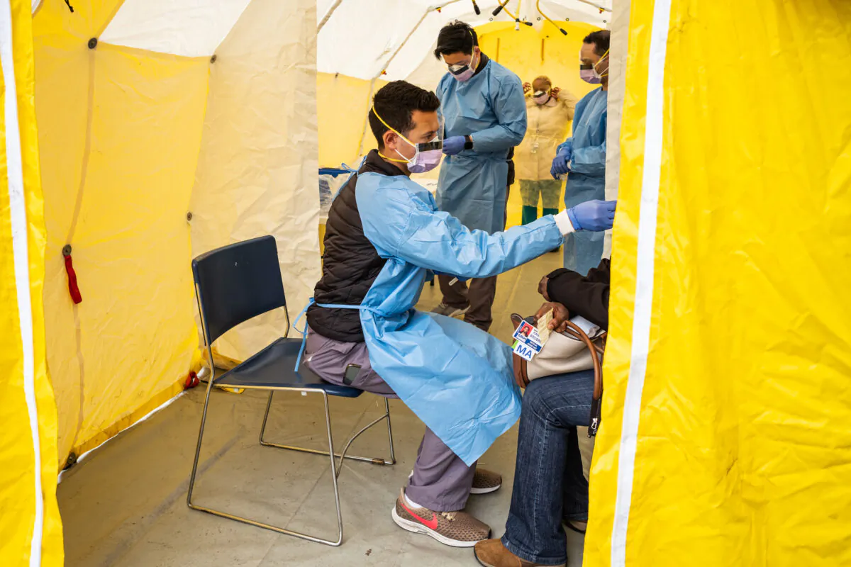 Doctors test hospital staff with flu-like symptoms for COVID-19 at St. Barnabas hospital in New York City, N.Y., on March 20, 2020. (Misha Friedman/Getty Images)