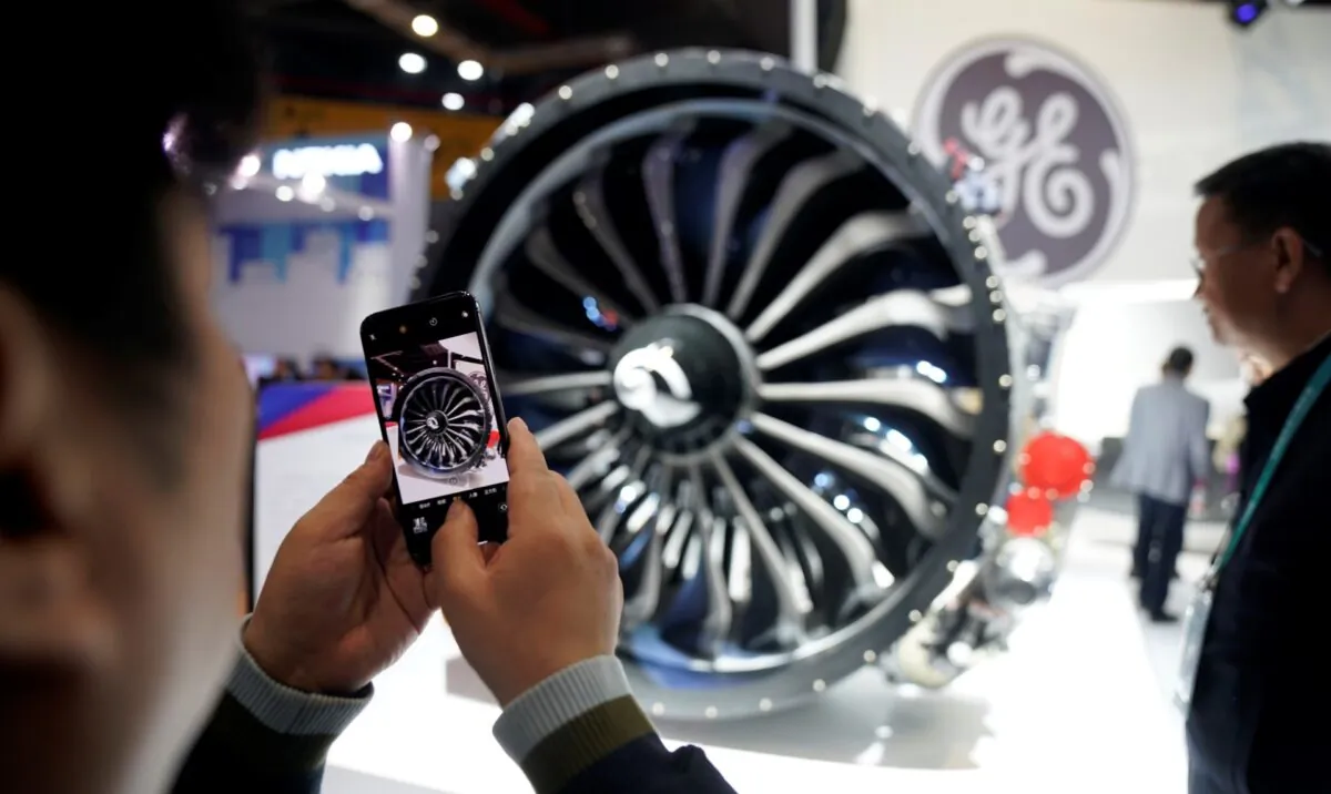 A man takes a picture of a General Electric engine during the China International Import Expo, at the National Exhibition and Convention Center in Shanghai, China, on Nov. 6, 2018. (Aly Song/File Photo/Reuters)